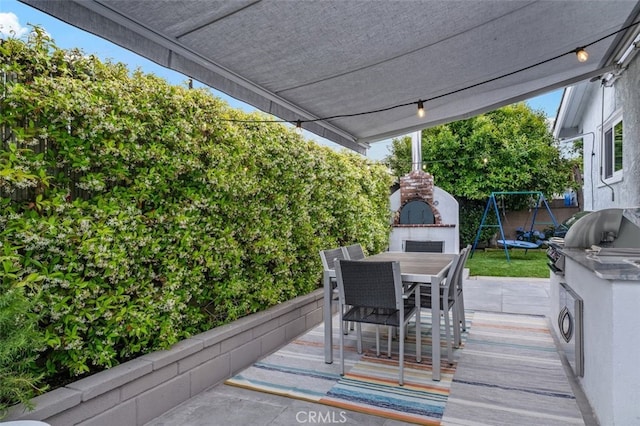 21225 Kent Ave, Torrance, CA 90503 - wooden terrace featuring outdoor dining area, a grill, an outdoor fireplace, a trampoline, and a patio area