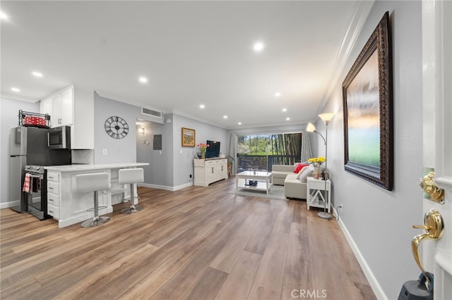 564 N Bellflower Blvd Unit 105, Long Beach, CA 90814 - living area with crown molding, light wood finished floors, recessed lighting, and bar area