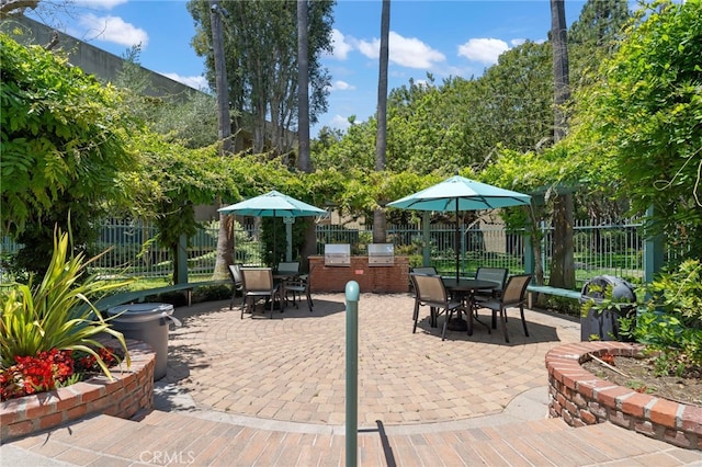 564 N Bellflower Blvd Unit 105, Long Beach, CA 90814 - fenced backyard featuring outdoor dining area, a patio area, and an outdoor kitchen
