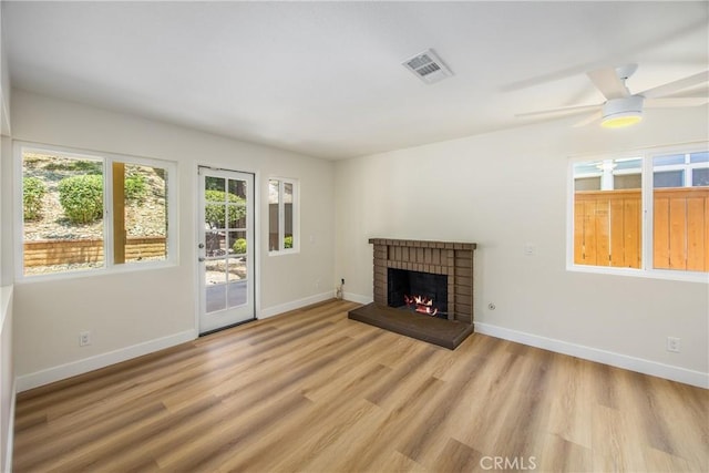 11142 Malone St, Rancho Cucamonga, CA 91701 - unfurnished living room featuring light wood-style floors, a ceiling fan, and a brick fireplace