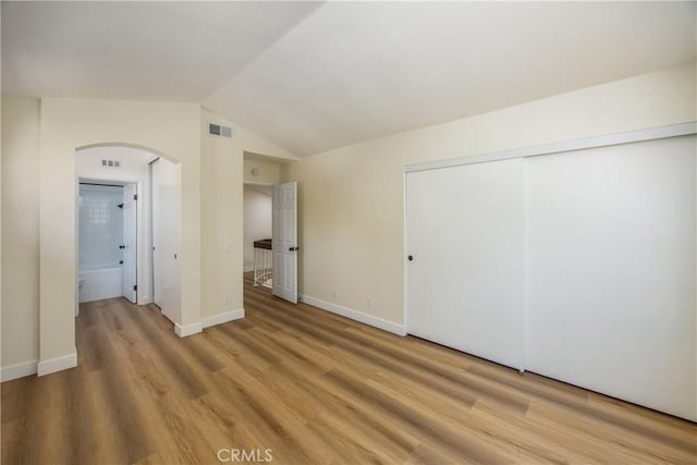 11142 Malone St, Rancho Cucamonga, CA 91701 - unfurnished bedroom featuring arched walkways, light wood-style floors, a closet, and vaulted ceiling