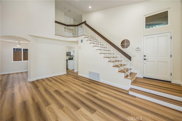 11142 Malone St, Rancho Cucamonga, CA 91701 - entryway featuring a high ceiling, stairway, wood finished floors, recessed lighting, and arched walkways