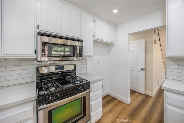 11142 Malone St, Rancho Cucamonga, CA 91701 - kitchen with stainless steel appliances, light countertops, wood finished floors, white cabinetry, and backsplash