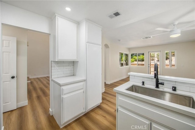 11142 Malone St, Rancho Cucamonga, CA 91701 - kitchen with light countertops, white cabinets, a ceiling fan, light wood-type flooring, and recessed lighting