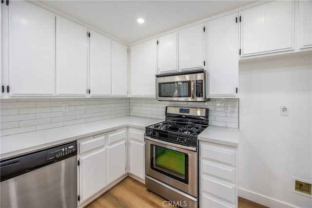11142 Malone St, Rancho Cucamonga, CA 91701 - kitchen with appliances with stainless steel finishes, light countertops, tasteful backsplash, white cabinets, and recessed lighting