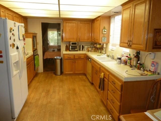 15411 Runnymede St, Van Nuys, CA 91406 - kitchen featuring white fridge with ice dispenser, light wood-style floors, and brown cabinets