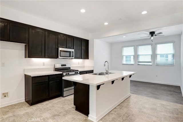 13219 Shaw Ln, Sylmar, CA 91342 - kitchen with appliances with stainless steel finishes, a ceiling fan, recessed lighting, light countertops, and a kitchen bar