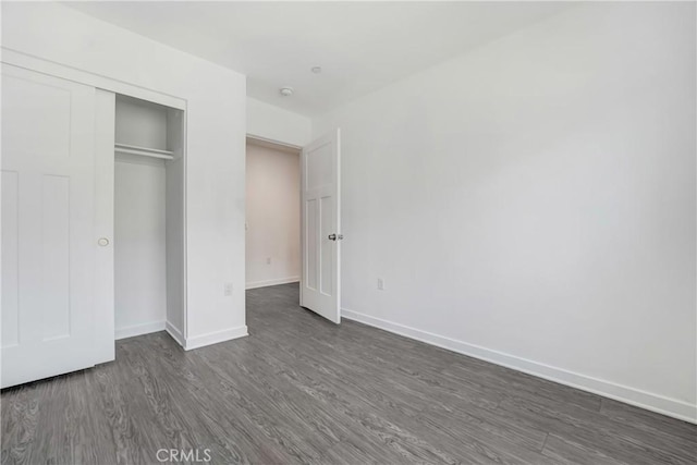 13219 Shaw Ln, Sylmar, CA 91342 - unfurnished bedroom with dark wood finished floors and a closet