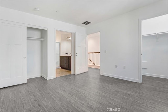 13219 Shaw Ln, Sylmar, CA 91342 - unfurnished bedroom featuring a closet, wood finished floors, and ensuite bathroom
