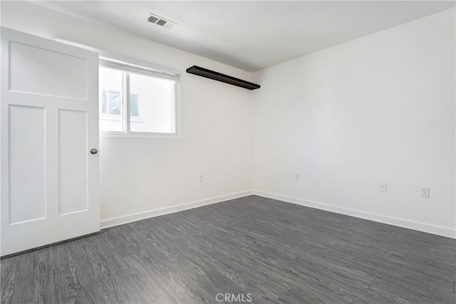 13219 Shaw Ln, Sylmar, CA 91342 - unfurnished room with dark wood-style flooring and baseboards