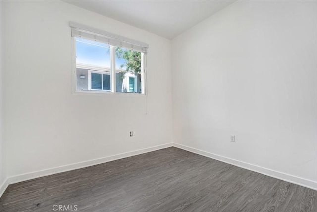 13219 Shaw Ln, Sylmar, CA 91342 - spare room featuring dark wood-style floors and baseboards