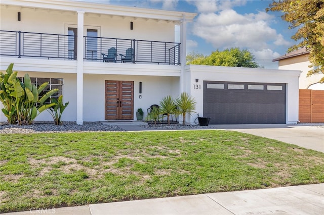 131 Gemini St, Lompoc, CA 93436 - view of front of property with french doors, a balcony, concrete driveway, a garage, and a front lawn
