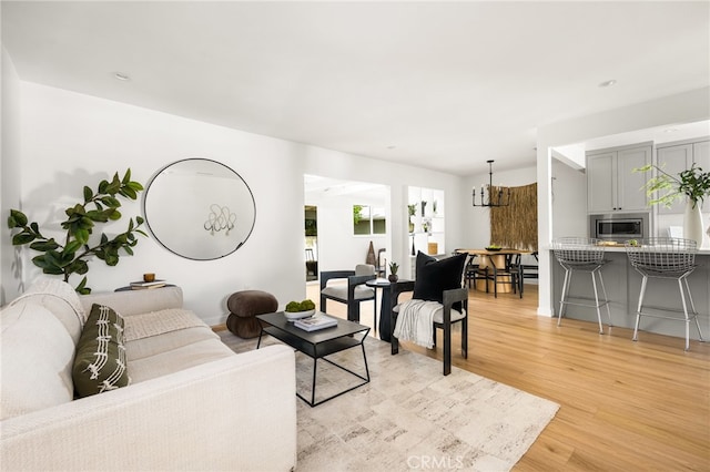 17216 Lorne St, Van Nuys, CA 91406 - living area featuring light wood finished floors and a chandelier