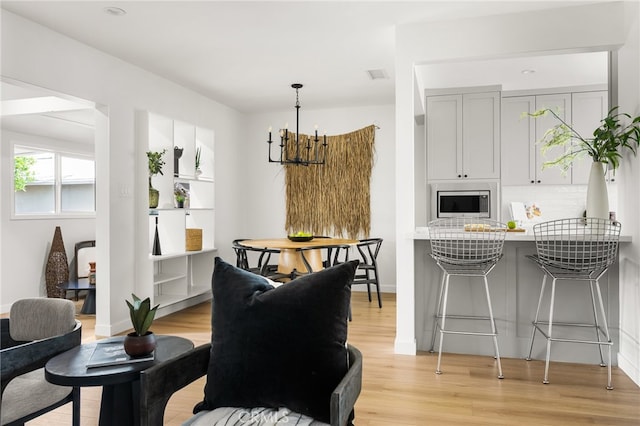 17216 Lorne St, Van Nuys, CA 91406 - dining room with light wood-type flooring and a chandelier