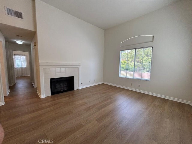 28741 La Triana, Laguna Niguel, CA 92677 - unfurnished living room with wood finished floors, a fireplace, and a high ceiling
