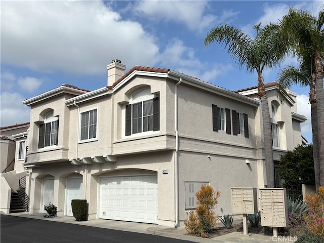 28741 La Triana, Laguna Niguel, CA 92677 - view of home's exterior with mail area, a chimney, stucco siding, and a tiled roof