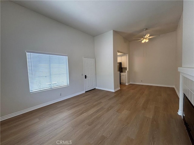28741 La Triana, Laguna Niguel, CA 92677 - unfurnished living room with a ceiling fan, wood finished floors, high vaulted ceiling, and a tile fireplace