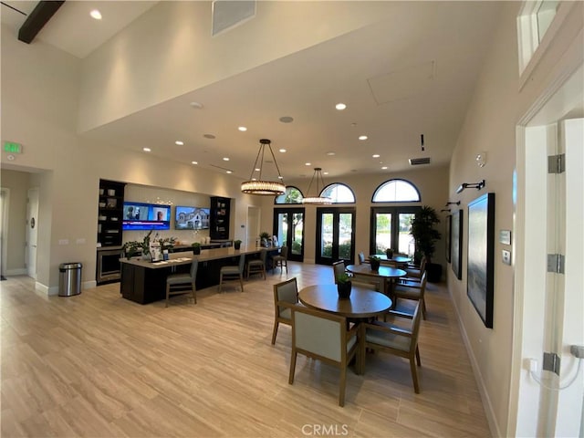 227 Carlow, Irvine, CA 92618 - dining space featuring a towering ceiling, recessed lighting, light wood-type flooring, and french doors