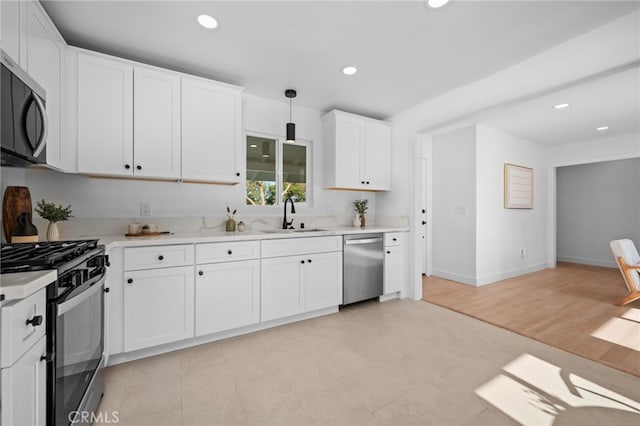 676 Alvin St, San Diego, CA 92114 - kitchen with appliances with stainless steel finishes, light countertops, white cabinets, recessed lighting, and decorative light fixtures