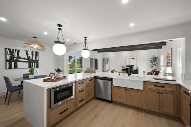 6863 Tanglewood Rd, San Diego, CA 92111 - kitchen featuring stainless steel appliances, light countertops, light wood finished floors, recessed lighting, and pendant lighting