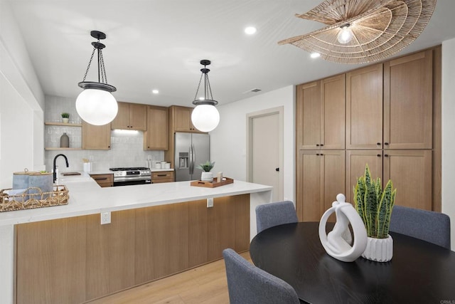 6863 Tanglewood Rd, San Diego, CA 92111 - kitchen with appliances with stainless steel finishes, a peninsula, open shelves, light wood finished floors, and light countertops