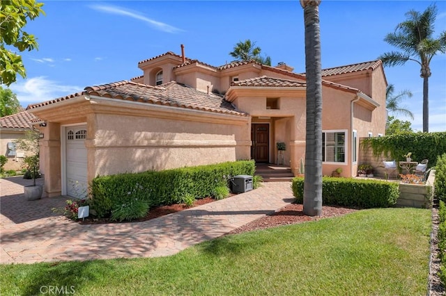 15736 Milne Cir, Moorpark, CA 93021 - mediterranean / spanish-style house featuring stucco siding, a garage, a tiled roof, a front lawn, and a chimney