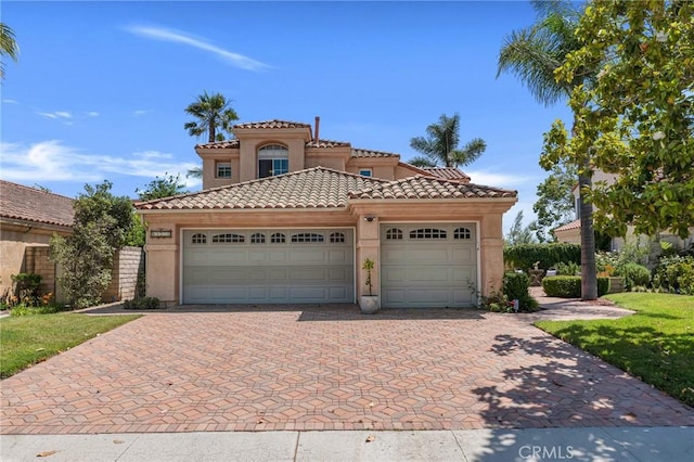 15736 Milne Cir, Moorpark, CA 93021 - mediterranean / spanish house with decorative driveway, a garage, stucco siding, and a tile roof