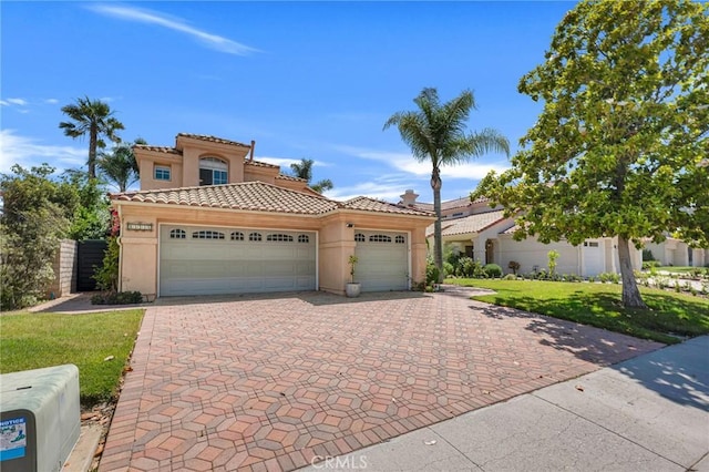 15736 Milne Cir, Moorpark, CA 93021 - mediterranean / spanish home featuring stucco siding, decorative driveway, a garage, a tile roof, and a front lawn