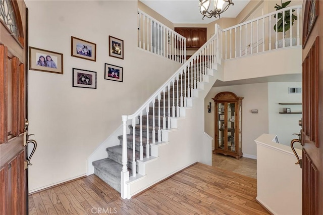 15736 Milne Cir, Moorpark, CA 93021 - entryway featuring stairs, light wood-type flooring, a chandelier, and a high ceiling
