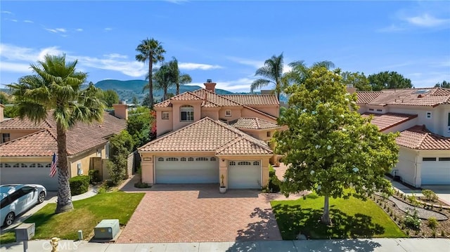 15736 Milne Cir, Moorpark, CA 93021 - mediterranean / spanish home with a tiled roof, an attached garage, decorative driveway, and stucco siding