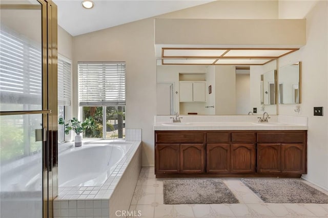 15736 Milne Cir, Moorpark, CA 93021 - full bathroom featuring a garden tub, double vanity, vaulted ceiling, and tile patterned flooring