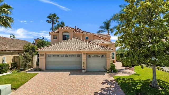 15736 Milne Cir, Moorpark, CA 93021 - mediterranean / spanish-style home featuring a tile roof, an attached garage, stucco siding, driveway, and a front lawn