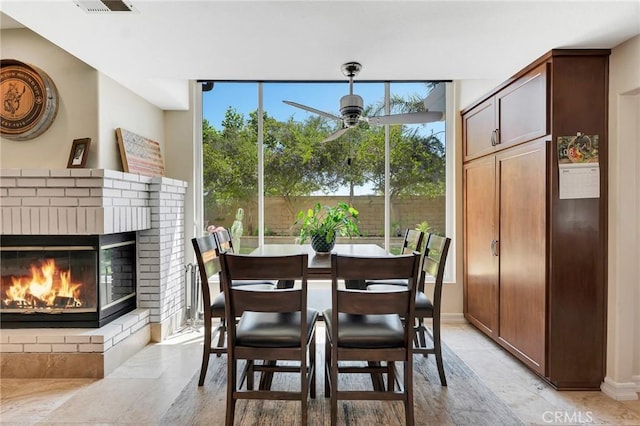 15736 Milne Cir, Moorpark, CA 93021 - dining area with a brick fireplace, a ceiling fan, and expansive windows