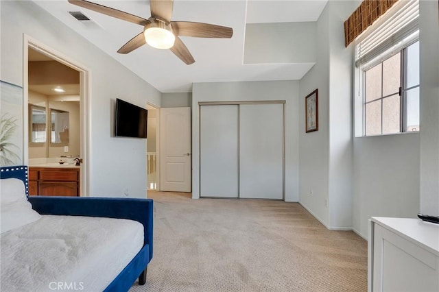 15736 Milne Cir, Moorpark, CA 93021 - bedroom featuring light colored carpet, a closet, connected bathroom, and a ceiling fan