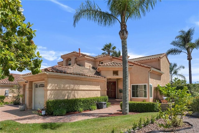 15736 Milne Cir, Moorpark, CA 93021 - mediterranean / spanish-style house with stucco siding, an attached garage, decorative driveway, and a tile roof