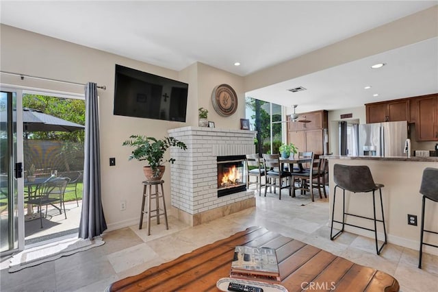 15736 Milne Cir, Moorpark, CA 93021 - living room featuring healthy amount of natural light, a brick fireplace, recessed lighting, light tile patterned floors, and a ceiling fan