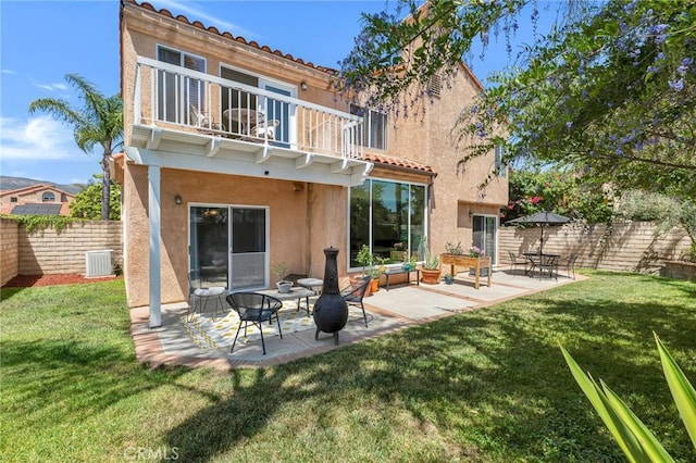 15736 Milne Cir, Moorpark, CA 93021 - back of property featuring a balcony, stucco siding, a fenced backyard, a tiled roof, and a patio area