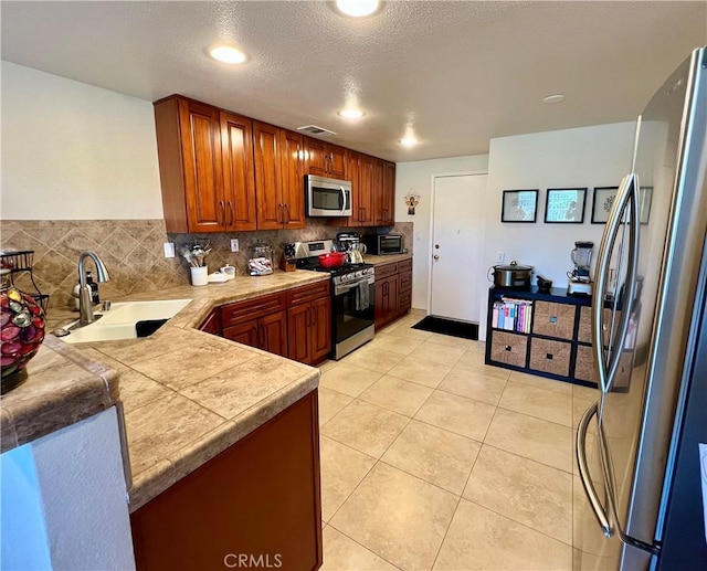 27347 Sahara Pl, Laguna Niguel, CA 92677 - kitchen featuring stainless steel appliances, decorative backsplash, brown cabinets, light tile patterned flooring, and recessed lighting