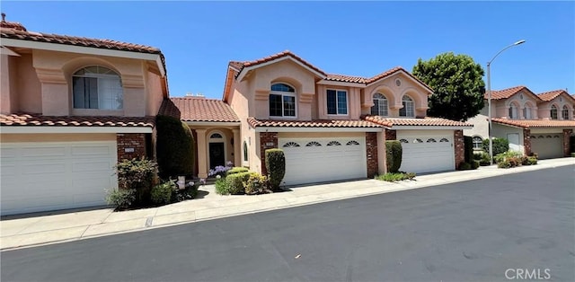 27347 Sahara Pl, Laguna Niguel, CA 92677 - mediterranean / spanish home with a tiled roof, brick siding, stucco siding, and a garage