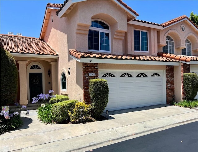 27347 Sahara Pl, Laguna Niguel, CA 92677 - mediterranean / spanish-style home featuring a tiled roof, an attached garage, and stucco siding