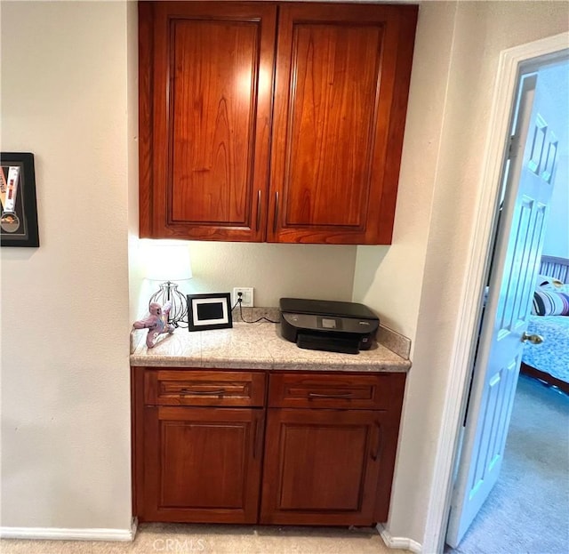 27347 Sahara Pl, Laguna Niguel, CA 92677 - kitchen featuring light countertops, brown cabinets, and light carpet
