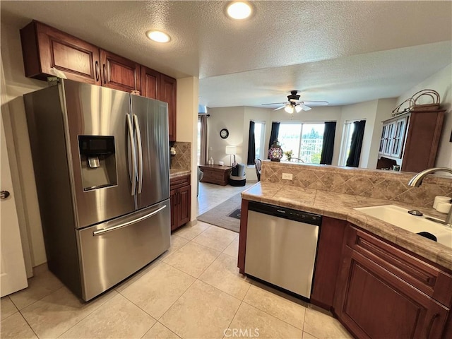 27347 Sahara Pl, Laguna Niguel, CA 92677 - kitchen featuring appliances with stainless steel finishes, tasteful backsplash, a textured ceiling, a ceiling fan, and light tile patterned floors