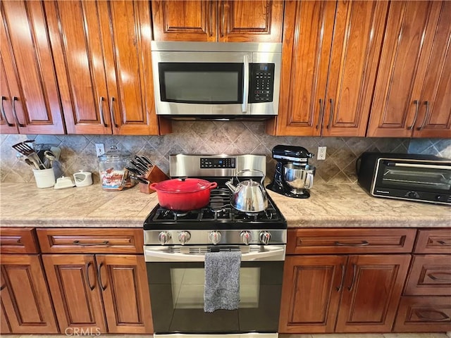 27347 Sahara Pl, Laguna Niguel, CA 92677 - kitchen with stainless steel appliances, brown cabinets, and tasteful backsplash