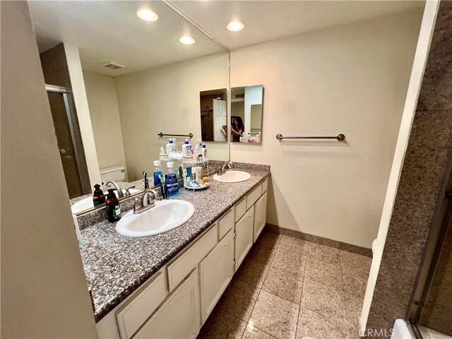 27347 Sahara Pl, Laguna Niguel, CA 92677 - bathroom with double vanity, a stall shower, recessed lighting, and granite tiled floors
