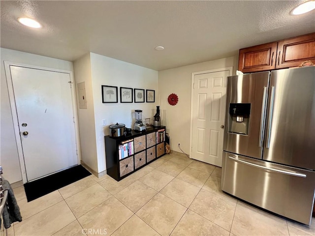 27347 Sahara Pl, Laguna Niguel, CA 92677 - kitchen featuring stainless steel fridge with ice dispenser, brown cabinetry, light tile patterned flooring, a textured ceiling, and recessed lighting