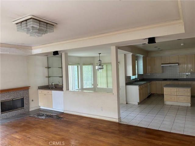 220 N Ynez Ave, Monterey Park, CA 91754 - kitchen featuring dark countertops, black electric stovetop, light wood-style floors, backsplash, and crown molding