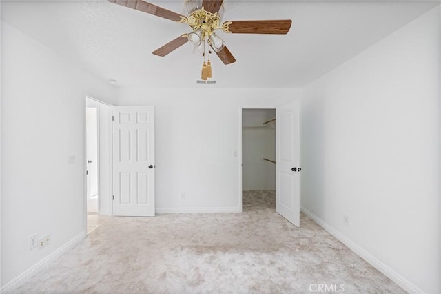 33030 Rd 233, North Fork, CA 93643 - unfurnished bedroom with carpet flooring, a walk in closet, a ceiling fan, and a closet