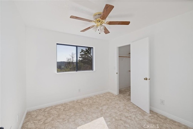 33030 Rd 233, North Fork, CA 93643 - unfurnished bedroom featuring carpet, a walk in closet, a ceiling fan, and a closet