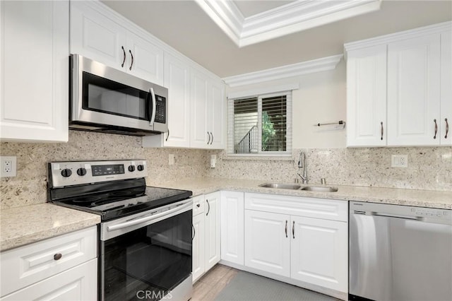 3034 Via Vis Unit A, Laguna Woods, CA 92637 - kitchen with stainless steel appliances, ornamental molding, decorative backsplash, and white cabinets