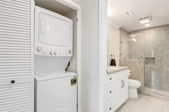 3034 Via Vis Unit A, Laguna Woods, CA 92637 - laundry room with stacked washer / dryer and light tile patterned floors